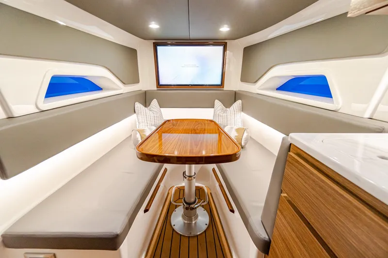 Slide: The Image of Luxurious interior of 2025 Valhalla Boatworks V-46 with modern seating and wooden table. - 21
