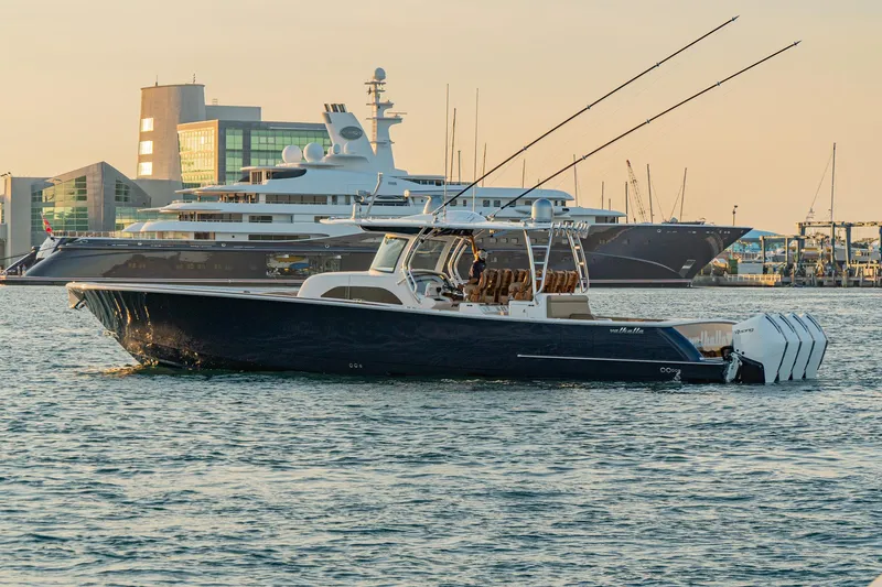Slide: The Image of 2025 Valhalla Boatworks V-46 in marina with luxury yachts in background. - 5