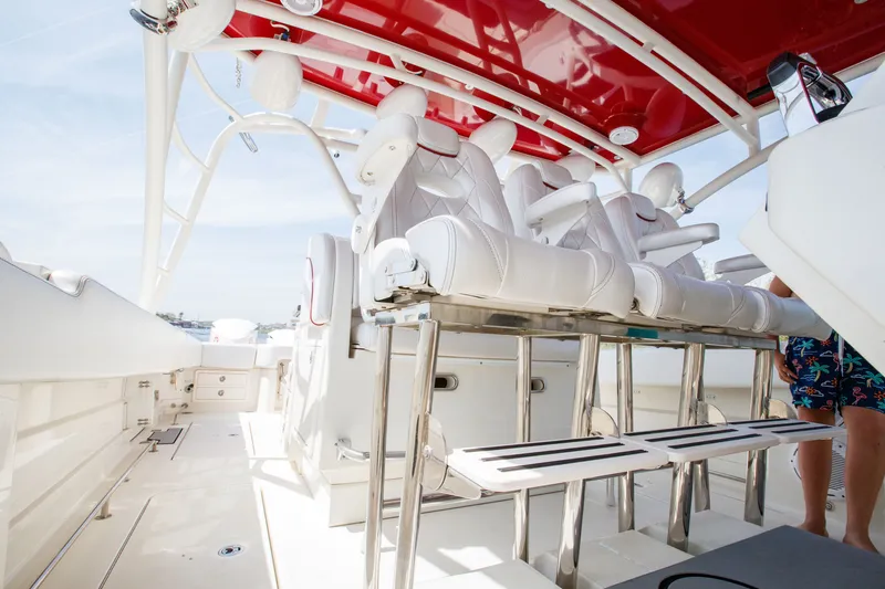 Slide: The Image of 2013 Hydra-Sports 42 Siesta boat interior with white seating and red canopy. - 10