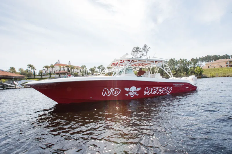 Slide: The Image of 2013 Hydra-Sports 42 Siesta boat with "No Mercy" text on red hull, on water. - 3