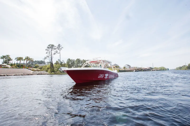 Slide: The Image of 2013 Hydra-Sports 42 Siesta boat on a scenic waterway with trees and houses. - 4