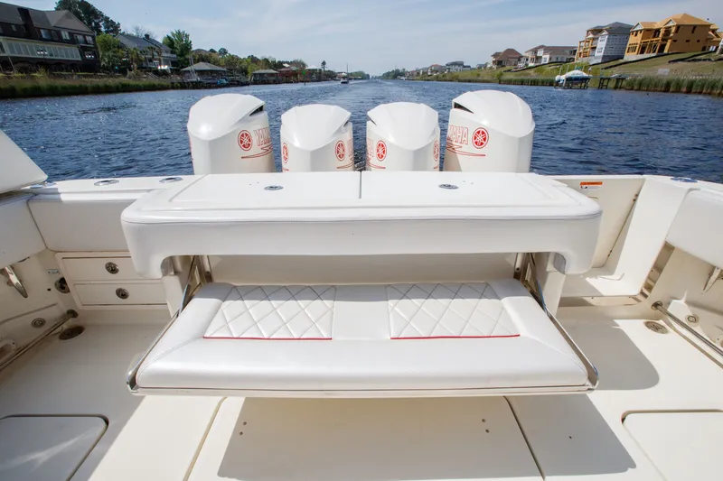 Slide: The Image of 2013 Hydra-Sports 42 Siesta boat with Yamaha engines, featuring a white cushioned seating area. - 7