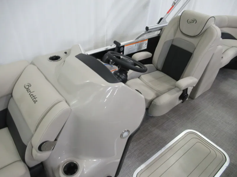 Slide: The Image of 2023 Barletta C22QC boat interior with steering console and comfortable seating. - 12