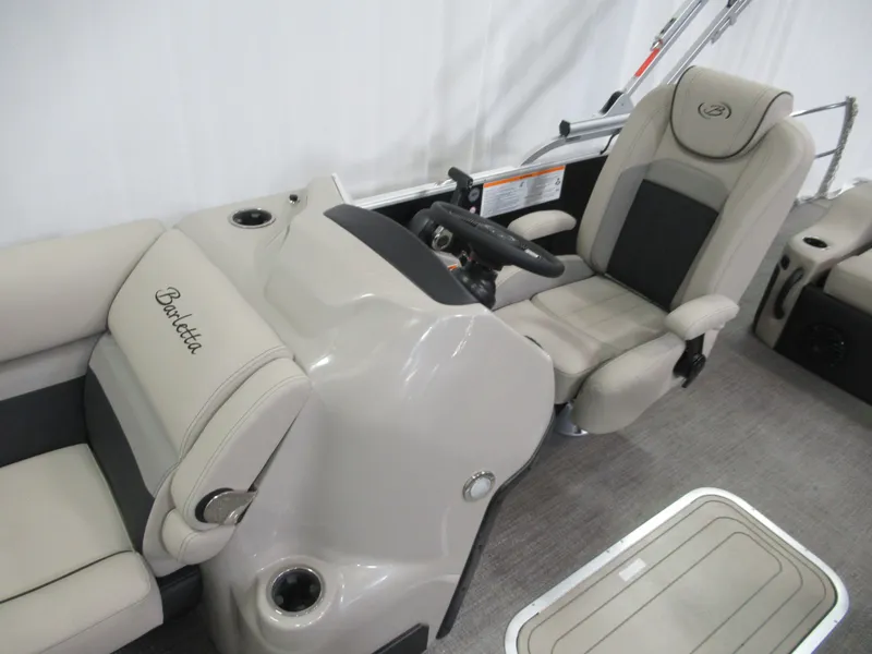 Slide: The Image of 2023 Barletta C22QC boat interior with beige seating and steering console. - 5