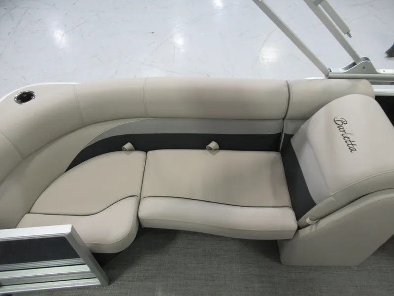 Slide: The Image of 2023 Barletta C22QC boat interior with beige seating and Barletta logo. - 8