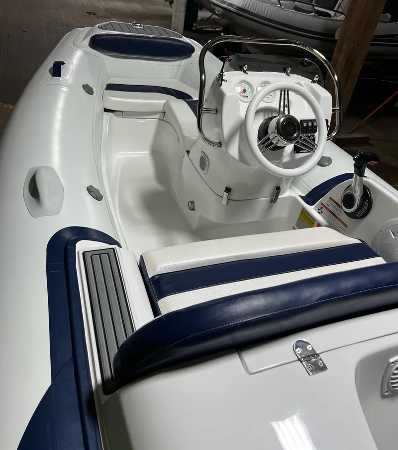 Slide: The Image of 2023 Walker Bay Generation 360 boat interior with steering console and seating. - 4
