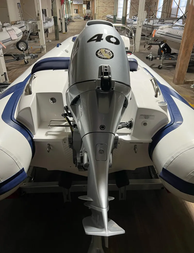 Slide: The Image of 2023 Walker Bay Generation 360 inflatable boat with a 40 HP outboard motor in a showroom. - 6
