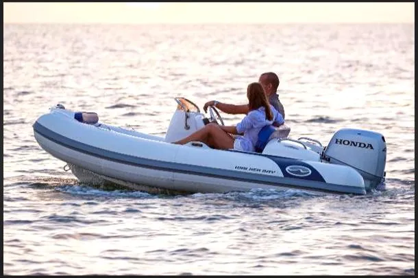 Slide: The Image of 2023 Walker Bay Generation 360 boat with Honda engine on the water. - 7