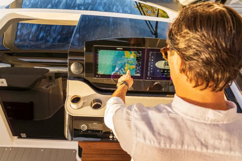 Slide: The Image of 2023 Sea Ray Sundancer 370 Outboard helm with touchscreen navigation system. - 16