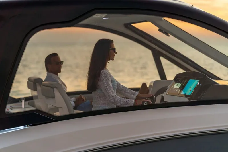 Slide: The Image of 2023 Sea Ray Sundancer 370 Outboard cruising at sunset with two passengers. - 18