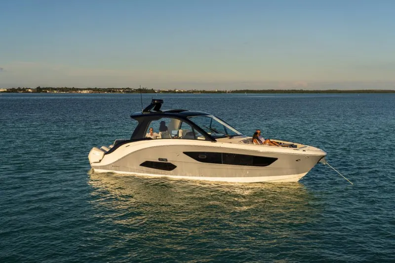 Slide: The Image of 2023 Sea Ray Sundancer 370 Outboard cruising on calm waters. - 3