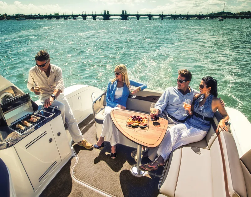 Slide: The Image of People enjoying a barbecue on a 2023 Sea Ray Sundancer 370 Outboard boat. - 45