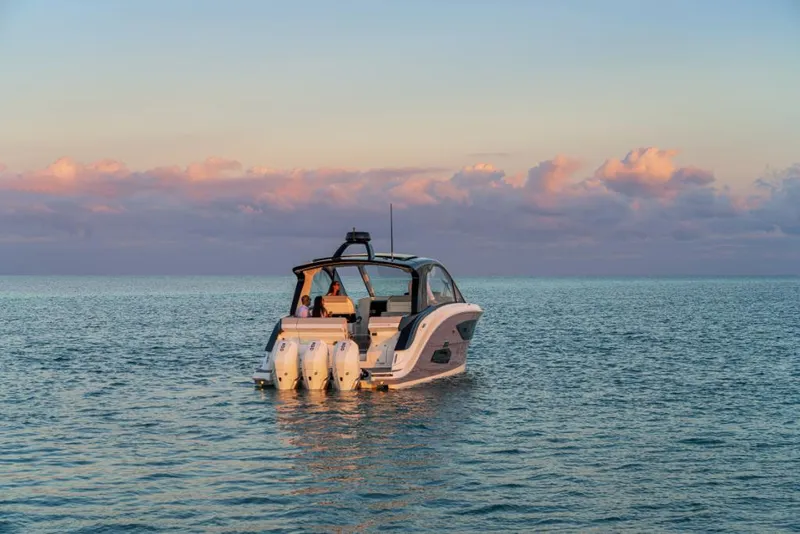 Slide: The Image of 2023 Sea Ray Sundancer 370 Outboard on calm ocean at sunset. - 5