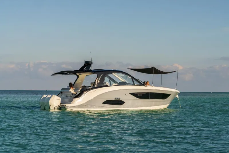 Slide: The Image of 2023 Sea Ray Sundancer 370 Outboard cruising on calm waters. - 7