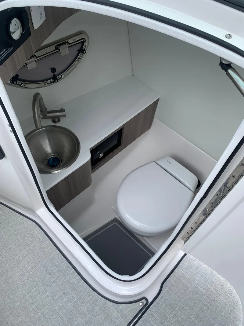 Slide: The Image of Interior of 2026 Regal LX4 boat with modern seating and steering wheel. - 17