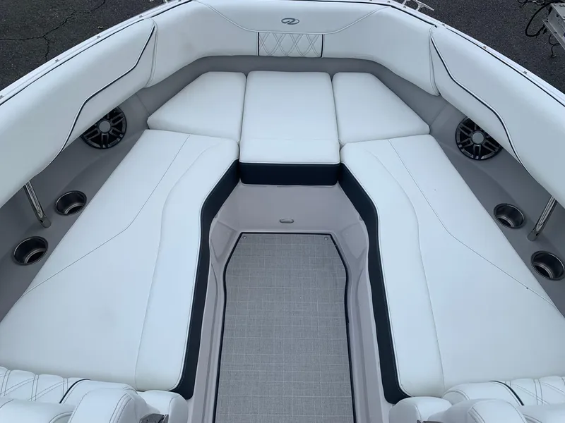 Slide: The Image of Interior of 2026 Regal LX4 boat with modern steering and white seating. - 19