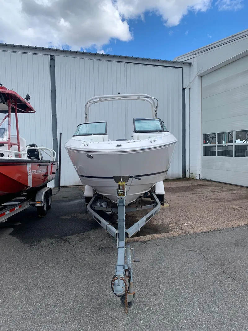 Slide: The Image of 2026 Regal LX4 boat in a sunlit garage, showcasing sleek design and modern features. - 2