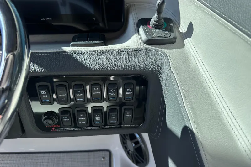 Slide: The Image of 2026 Regal LX4 boat dashboard with control switches and Garmin display. - 21