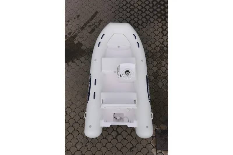 Slide: The Image of 2022 Capelli Tempest 340 LE Tender, top view, white inflatable boat on patterned ground. - 4