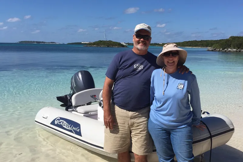 Slide: The Image of Couple enjoying a day by the Capelli Tempest 340 LE Tender, 2022 model, on a sunny beach. - 5