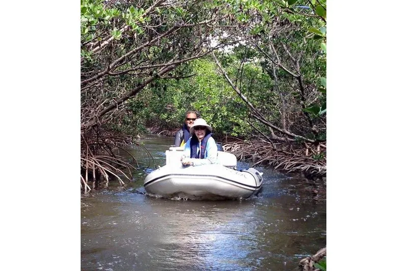 Slide: The Image of 2022 Capelli Tempest 340 LE Tender navigating through lush mangrove waterways. - 6