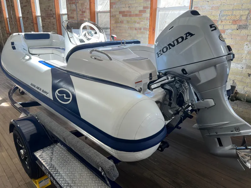 Slide: The Image of 2023 Walker Bay Generation 400 boat with Honda 50 outboard motor on trailer. - 1