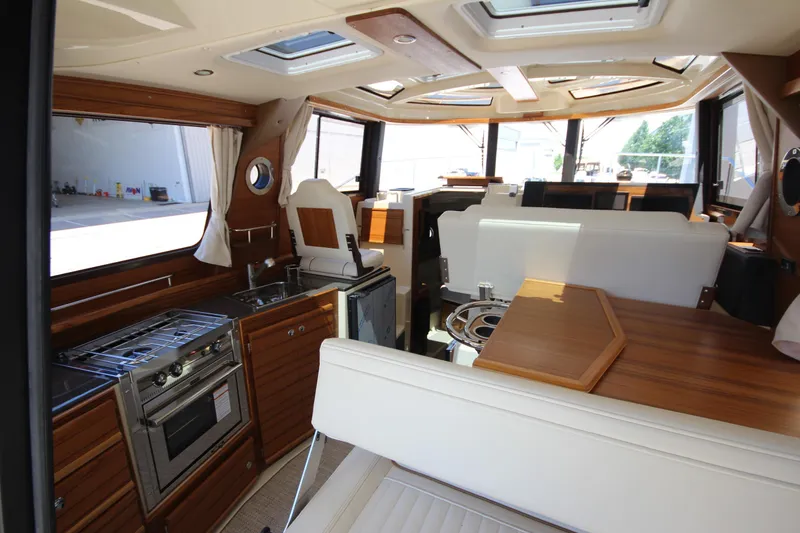 Slide: The Image of Interior of 2026 Ranger Tugs R-29 S, featuring modern kitchen and seating area. - 20