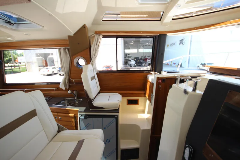 Slide: The Image of Interior of 2026 Ranger Tugs R-29 S, featuring elegant seating and modern amenities. - 28