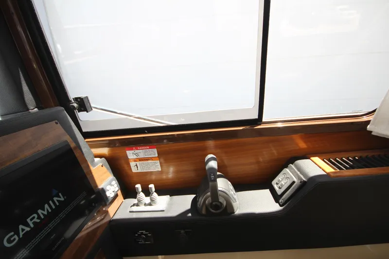 Slide: The Image of Interior helm controls of 2026 Ranger Tugs R-29 S with Garmin navigation system. - 31
