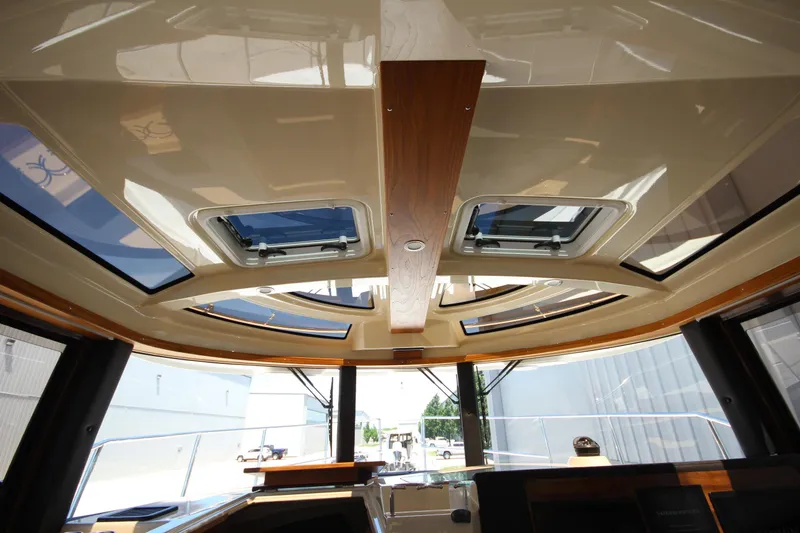 Slide: The Image of Interior view of 2026 Ranger Tugs R-29 S boat with skylights and wood accents. - 32