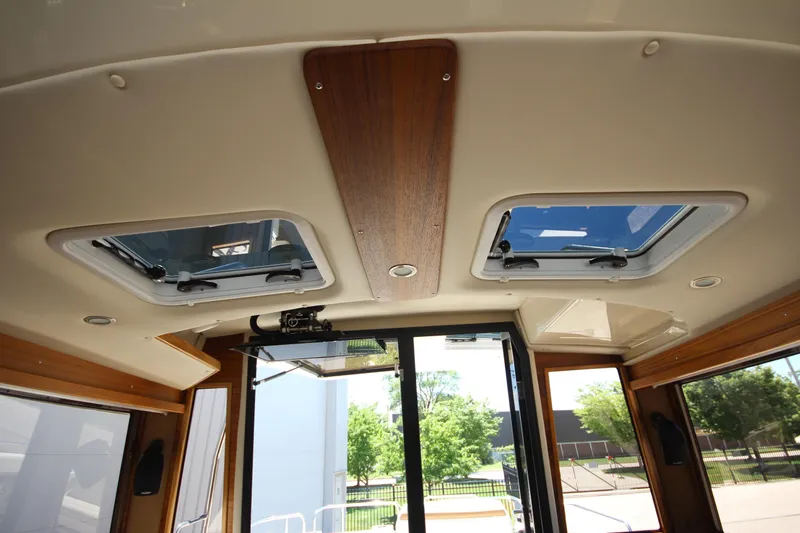 Slide: The Image of Interior view of 2026 Ranger Tugs R-29 S with skylights and wooden accents. - 33