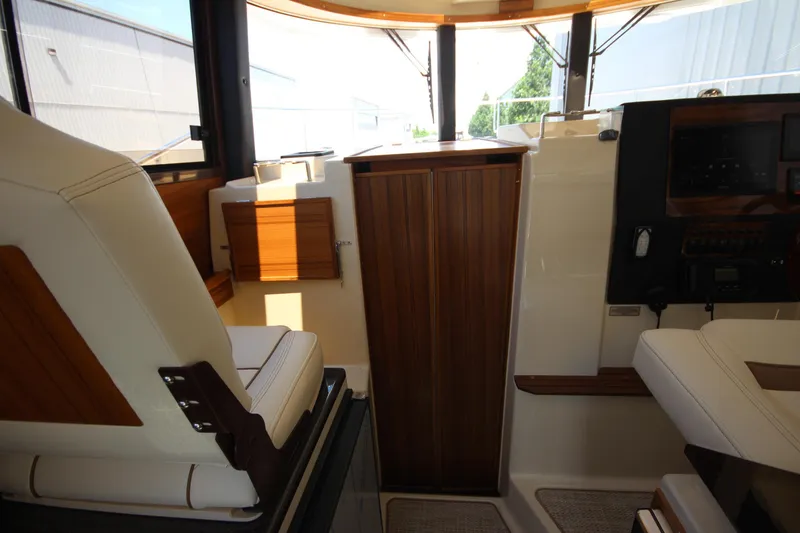 Slide: The Image of Interior of 2026 Ranger Tugs R-29 S, featuring elegant wood paneling and comfortable seating. - 35