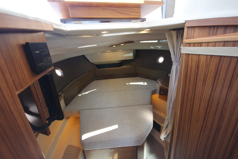 Slide: The Image of 2026 Ranger Tugs R-29 S interior cabin with wood finish and cozy seating. - 36
