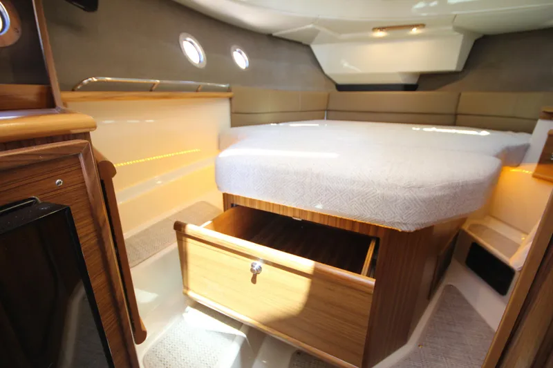 Slide: The Image of Interior cabin of 2026 Ranger Tugs R-29 S with bed and storage drawer. - 38