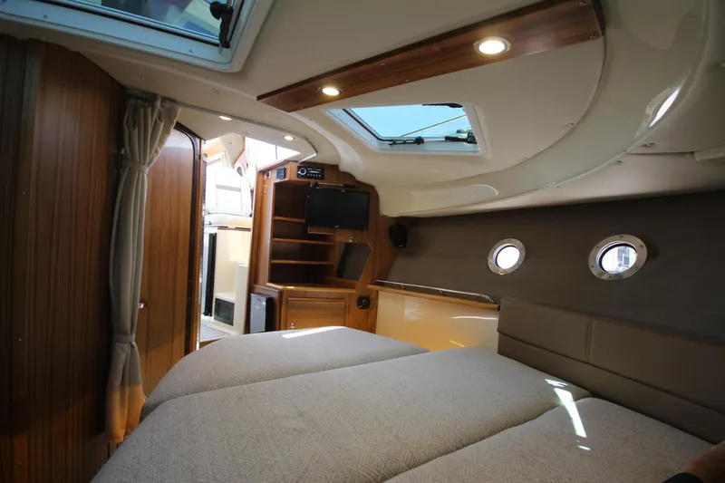 Slide: The Image of Interior of 2026 Ranger Tugs R-29 S, featuring cozy cabin with skylight and wood accents. - 39