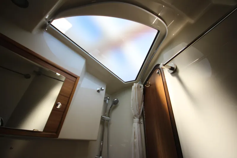 Slide: The Image of Interior of 2026 Ranger Tugs R-29 S bathroom with skylight and shower. - 42
