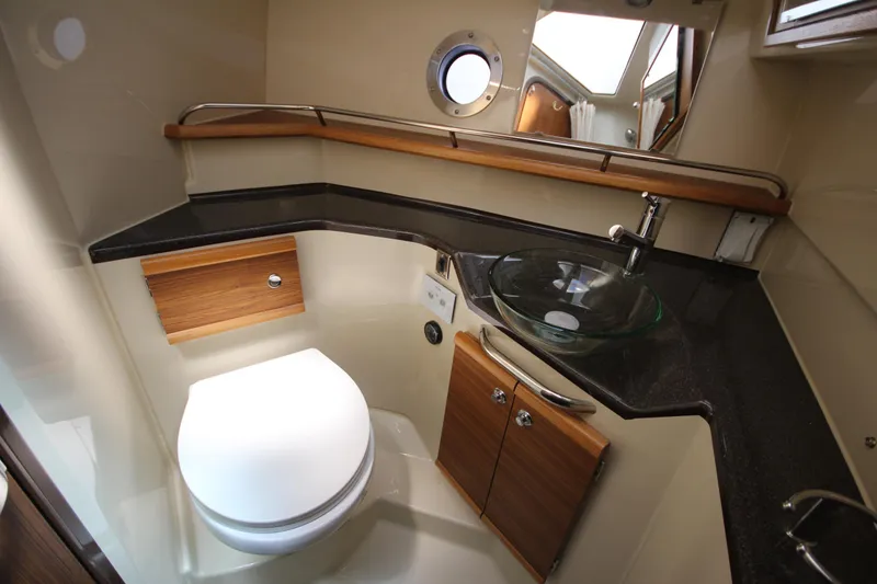 Slide: The Image of Modern bathroom in 2026 Ranger Tugs R-29 S boat with glass sink and wooden accents. - 43