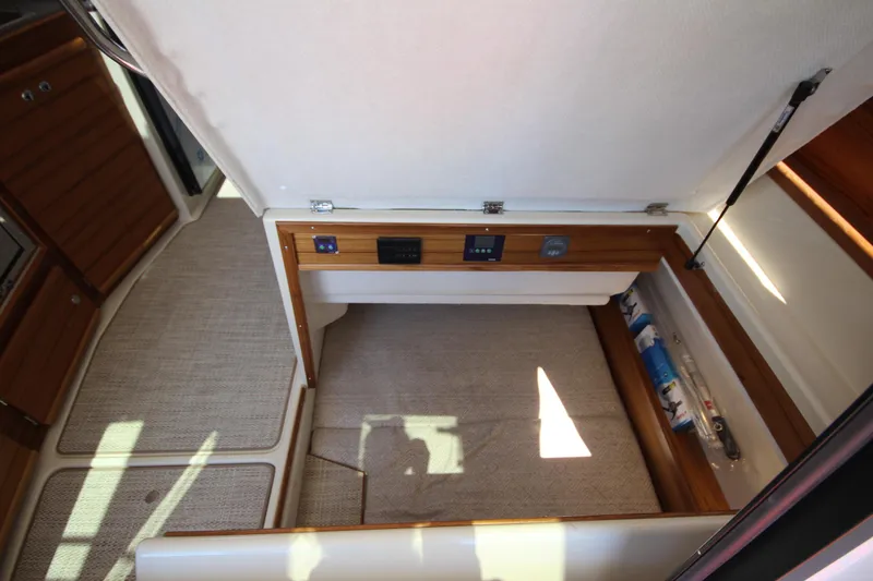 Slide: The Image of Interior storage compartment of 2026 Ranger Tugs R-29 S boat, featuring wooden accents. - 45