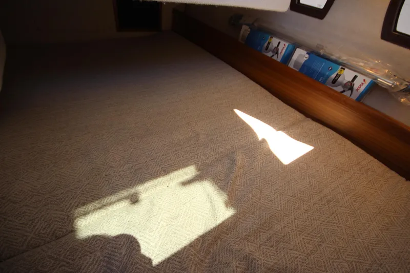 Slide: The Image of Interior cabin of 2026 Ranger Tugs R-29 S with sunlight on bed. - 46
