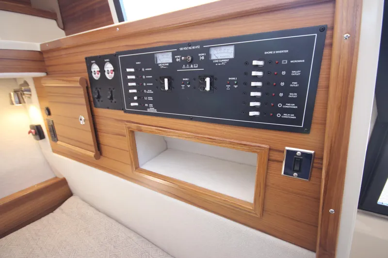 Slide: The Image of Electrical control panel in 2026 Ranger Tugs R-29 S boat interior, featuring wood accents. - 47