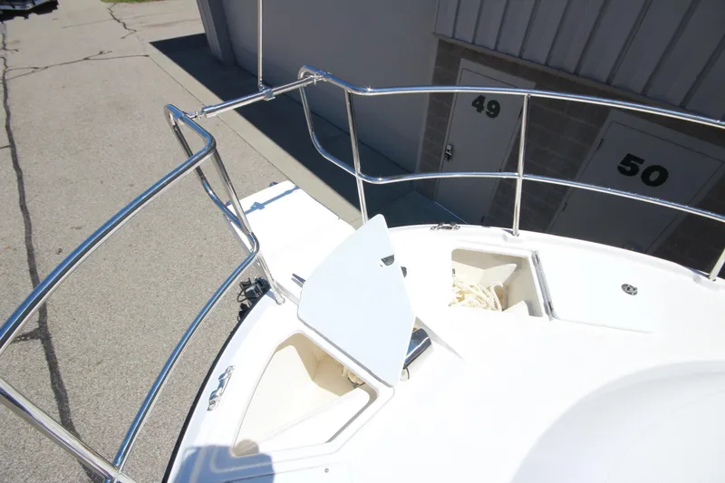 Slide: The Image of Bow of 2026 Ranger Tugs R-29 S with open storage compartments and railing. - 49