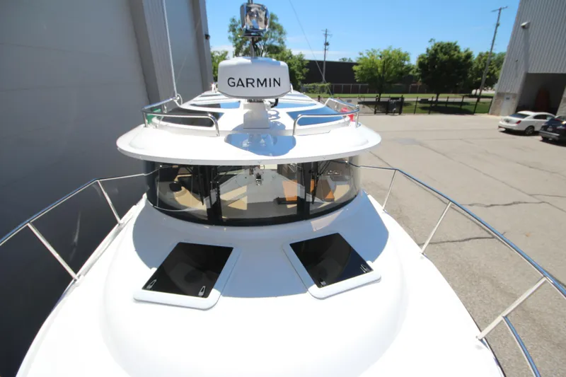 Slide: The Image of 2026 Ranger Tugs R-29 S boat with Garmin equipment, docked outdoors on a sunny day. - 51