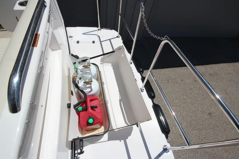 Slide: The Image of 2026 Ranger Tugs R-29 S boat deck with propane tanks and fuel container. - 9