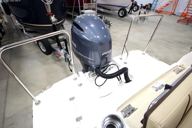 Slide: The Image of 2025 Ranger Tugs R-23 boat with Yamaha 200 outboard motor in showroom. - 11