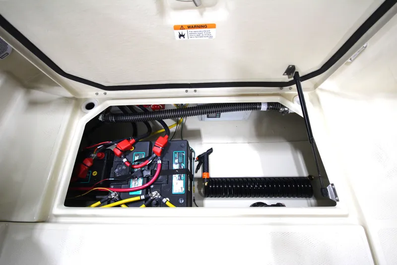 Slide: The Image of Battery compartment of 2025 Ranger Tugs R-23 boat with wiring and components. - 19