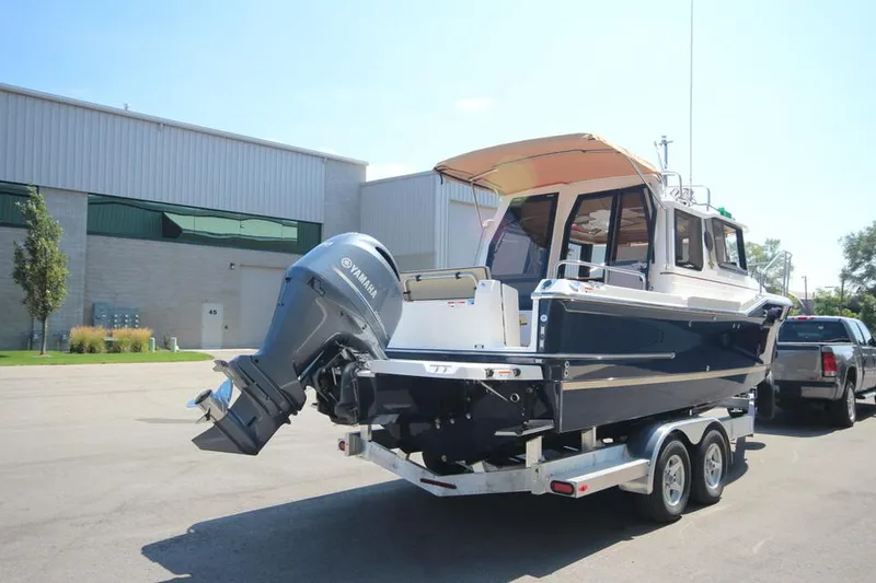 Slide: The Image of 2025 Ranger Tugs R-23 boat on a trailer with an outboard motor. - 2