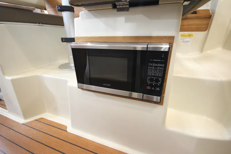 Slide: The Image of Built-in microwave in the 2025 Ranger Tugs R-23 boat interior. - 32