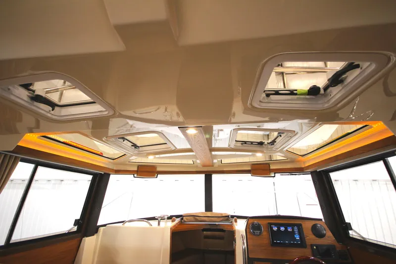 Slide: The Image of 2025 Ranger Tugs R-23 boat interior with skylights and modern dashboard. - 41