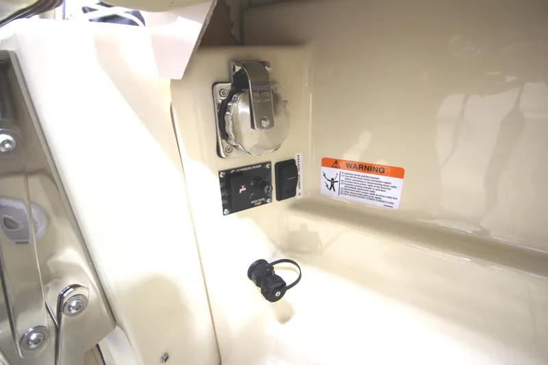 Slide: The Image of 2025 Ranger Tugs R-23 interior detail showing electrical panel and warning label. - 20