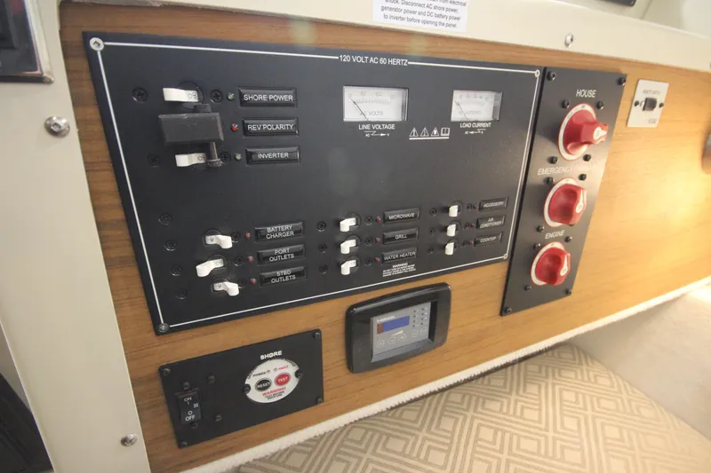 Slide: The Image of Electrical control panel of 2025 Ranger Tugs R-23 boat with switches and gauges. - 38